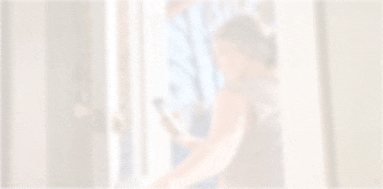 Woman checking her blood glucose on her smartphone as she walks out the door
