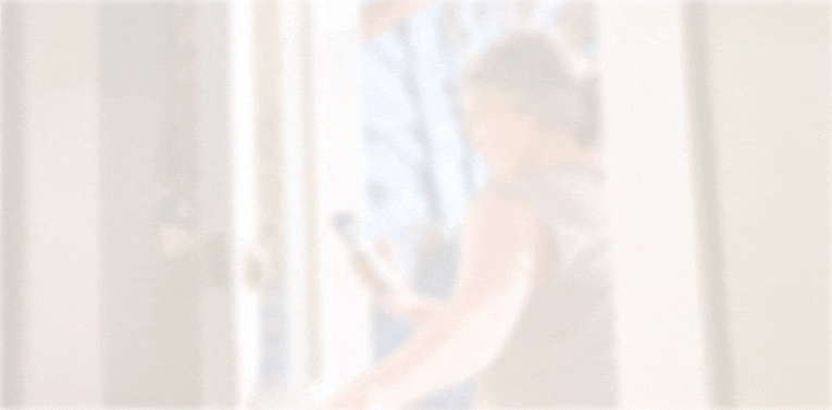 Woman checking her blood glucose on her smartphone as she walks out the door