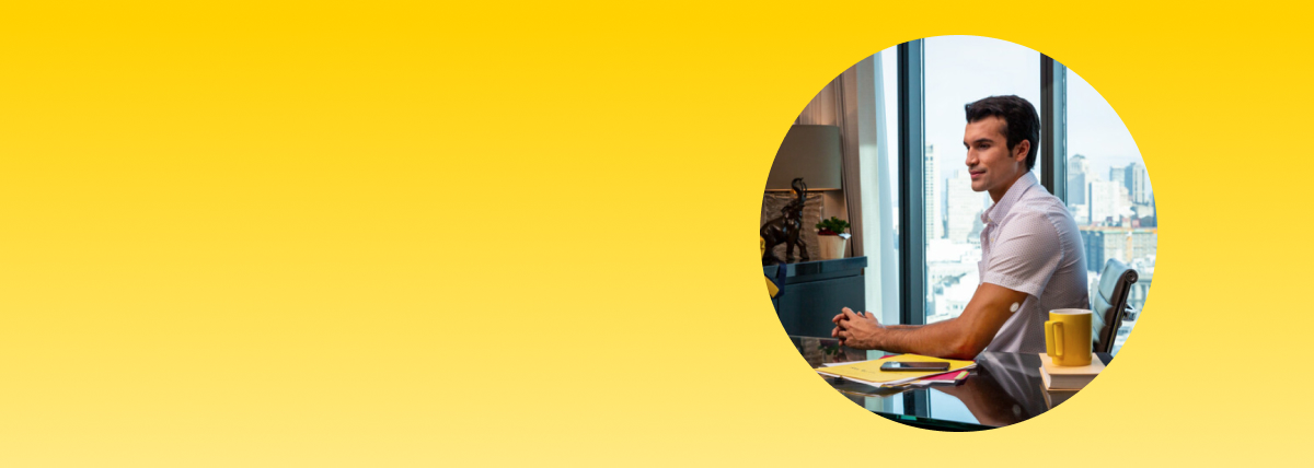 Man working at a desk while wearing a FreeStyle Libre systems sensor