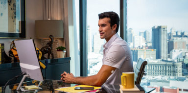 Man working at a desk while wearing a FreeStyle Libre systems sensor
