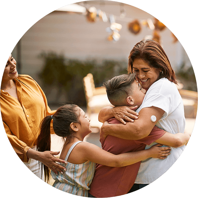Grandmother hugging her grandchild while wearing a sensor