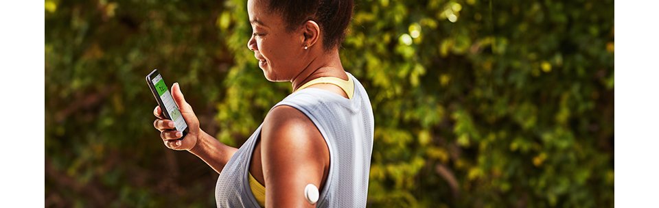 Woman on the phone checking her glucose levels