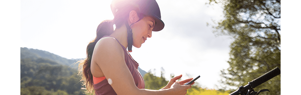 Woman using the Ypsomed insulin pump with the FreeStyle Libre 3 system