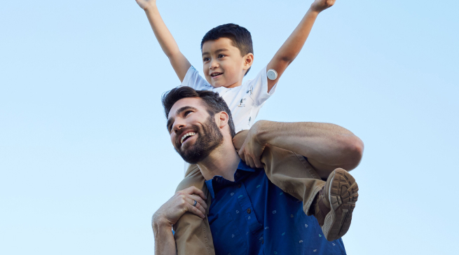 Man holding child on his shoulders