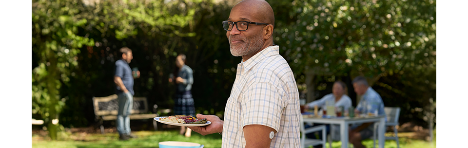 Man at BBQ wearing FreeStyle Libre 2 sensor