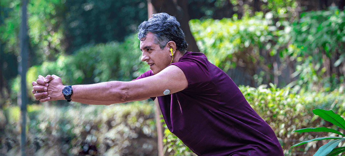 A man exercises outdoors wearing his Freestyle Libre sensor