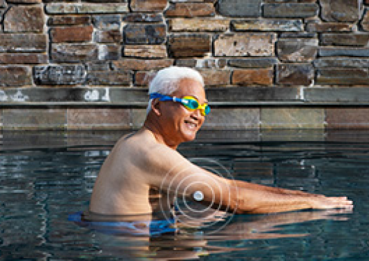 A man wearing a glucose sensor goes for a swim.