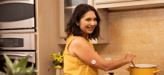 A woman wearing a Freestyle Libre sensor cooks dinner 