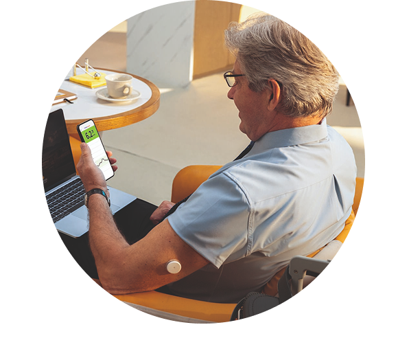 a man looking at his glucose data on his phone