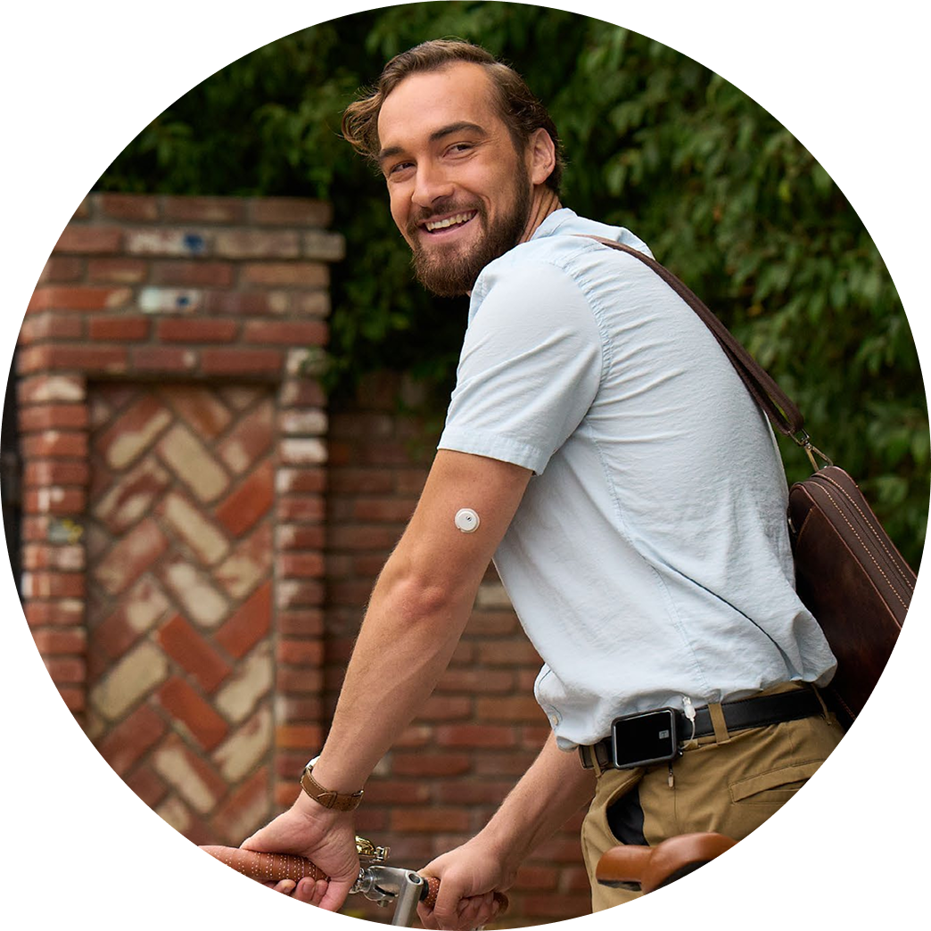 Man on bike wearing Libre 3 Plus sensor and Tandem Aid 