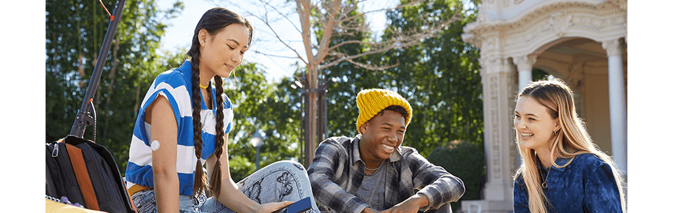 Teen wearing Libre 2 Plus sensor reviewing her data in FreeStyle LibreLink app