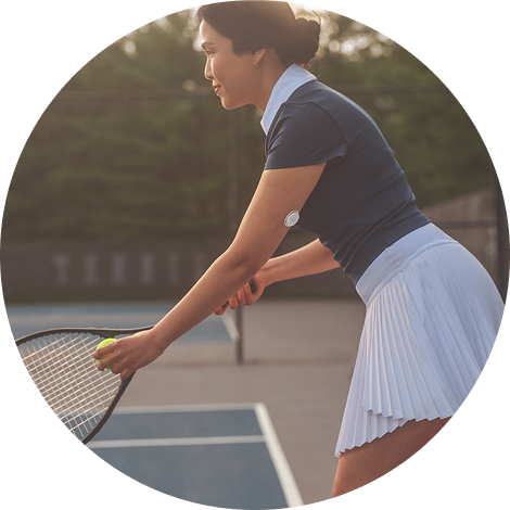 Tennis player getting ready to serve with sensor on her upper arm