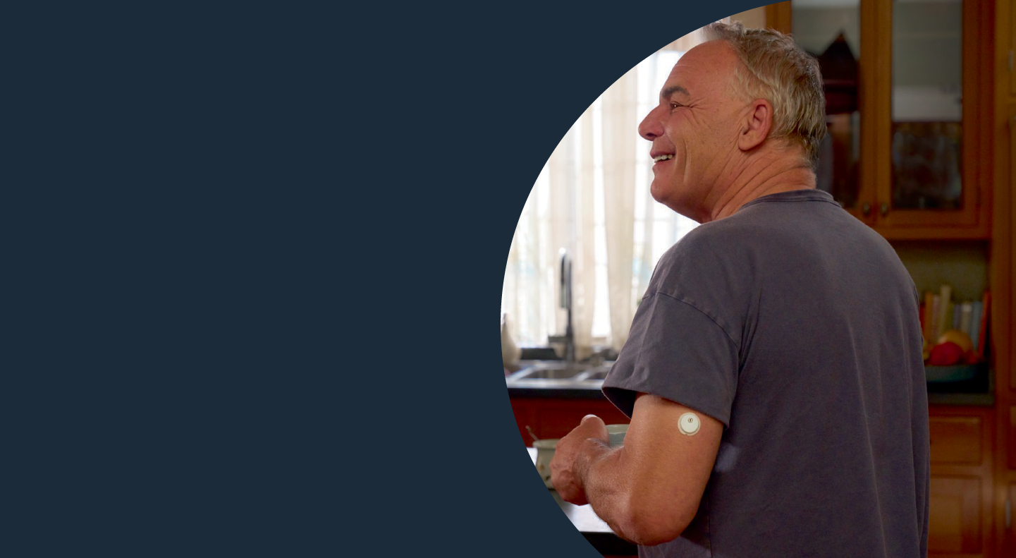 A man wearing a FreeStyle Libre sensor enjoying his morning coffee.