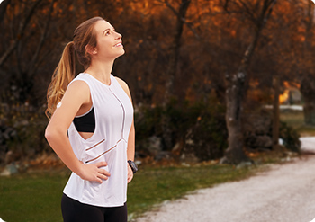 Women in gym clothes, outdoors, looking up at the sky.