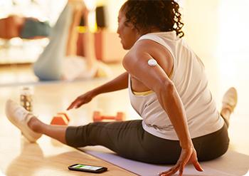 Woman doing stretch exercises on a mat