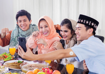 Group of friends taking a wefie over a meal