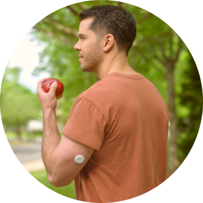 Man at a picnic wearing a FreeStyle Libre 2 Plus sensor