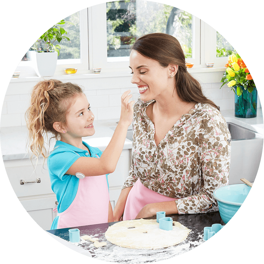 Mother and daughter baking and eating