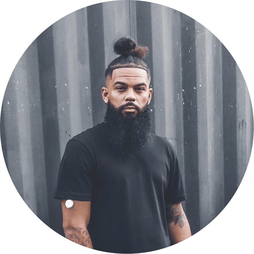 Testimonail Reece looking at the camera with a sensor on his arm