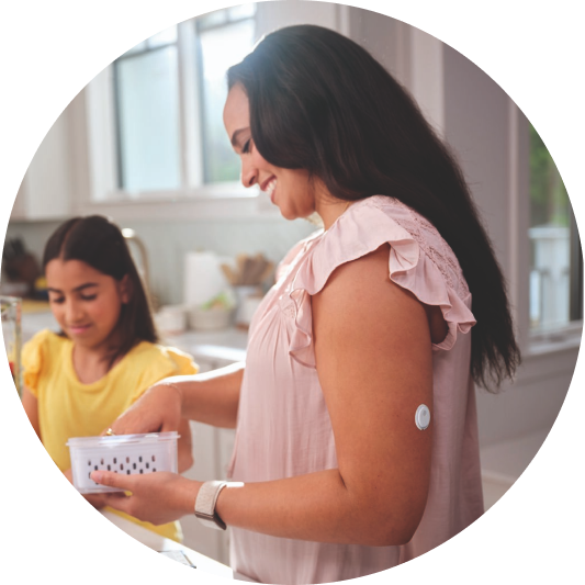 Mother wearing Libre 3 sensor and child in the kitchen