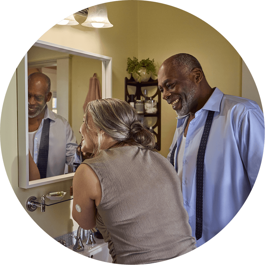 Man and woman wearing a sensor getting ready in front of a mirror