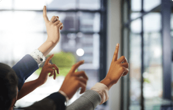 A bunch of raised arms sticking their pointer fingers out to ask questions.