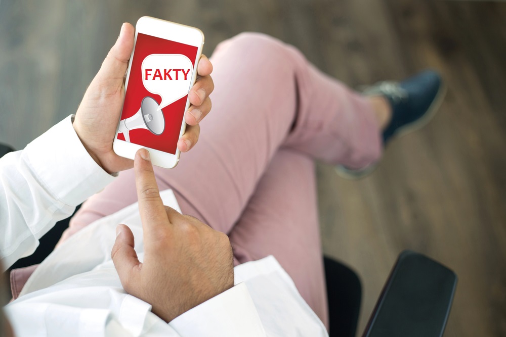 People using smart phone and FACTS announcement concept on screen