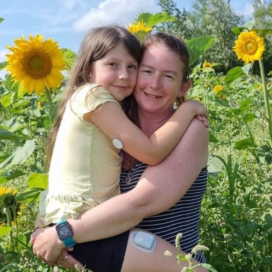 Mother holding daughter and smiling