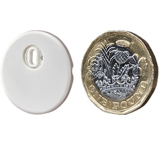 FreeStyle Libre 3 sensor alongside a one pound coin