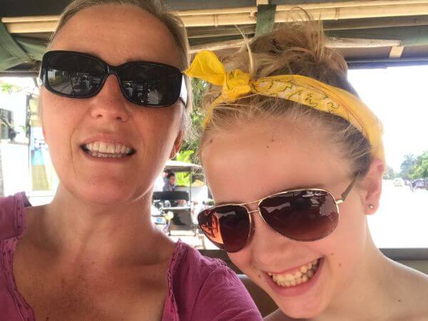 Mother and daughter taking a selfie smiling and wearing sunglasses