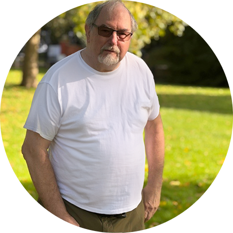 Ken Tait, blog author, posing infront of a grass area