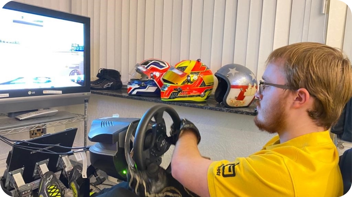 Ben Wallace sat at a driving simulation setup on his TV