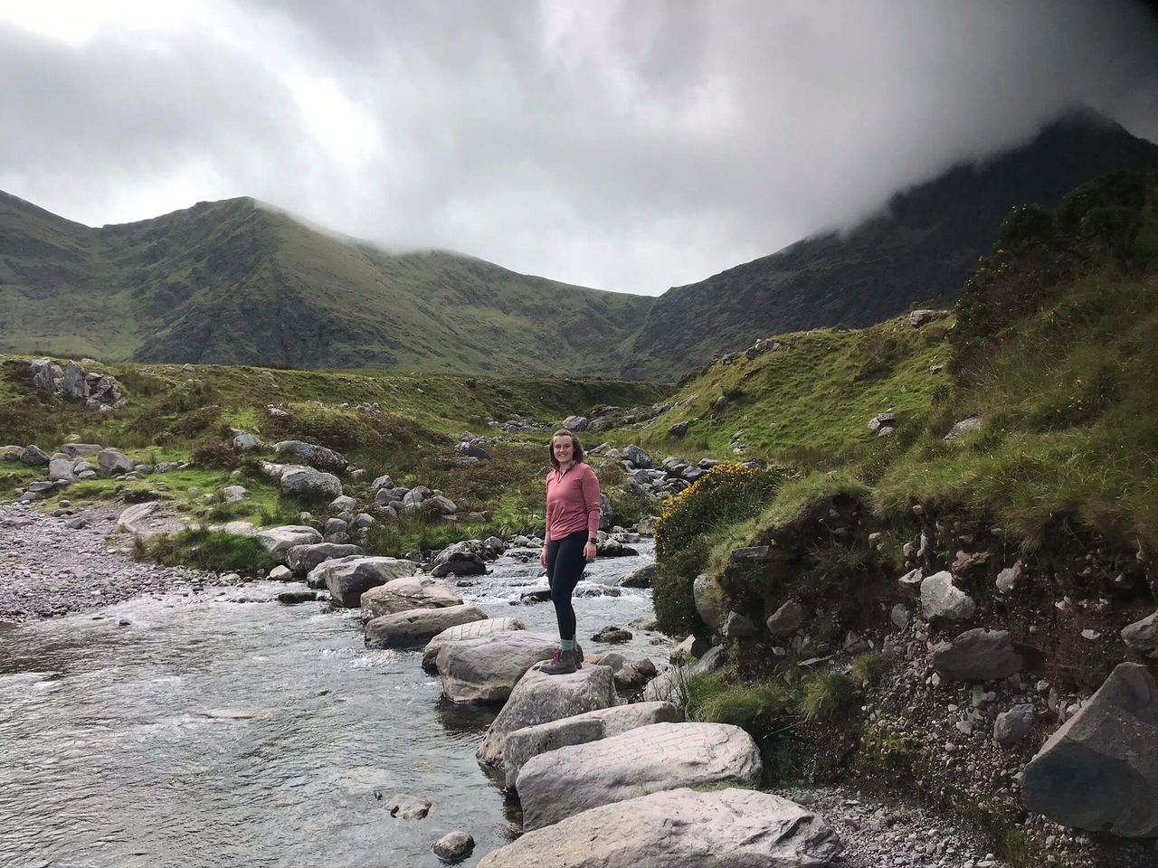 A women standing next to a river.