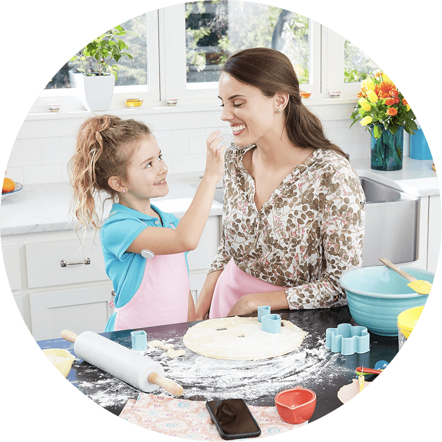 Woman and daughter with sensor baking in the kitchen