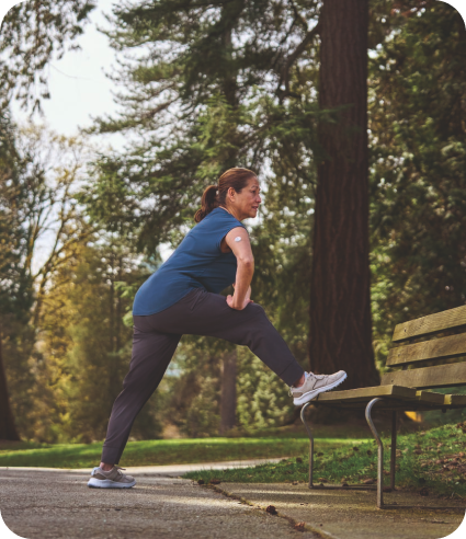 Woman stretching on a park bench in the park