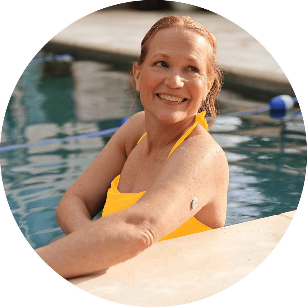 Woman relaxing in a swimming pool wearing a LIbre 3 sensor on her arm