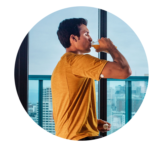 Man wearing a sensor and drinking juice