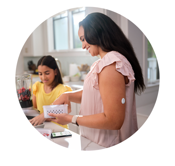 Mother and daughter preparing food. Mother is wearing a Libre 3 sensor