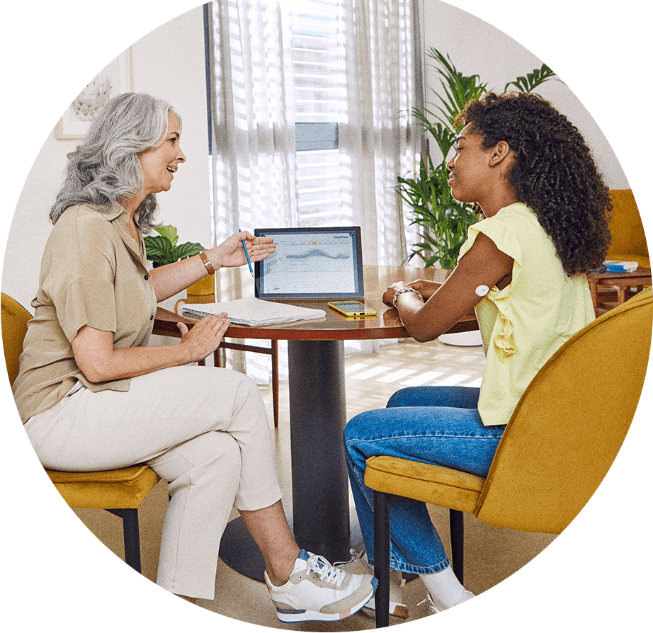 HCP and child reviewing LibreView data
