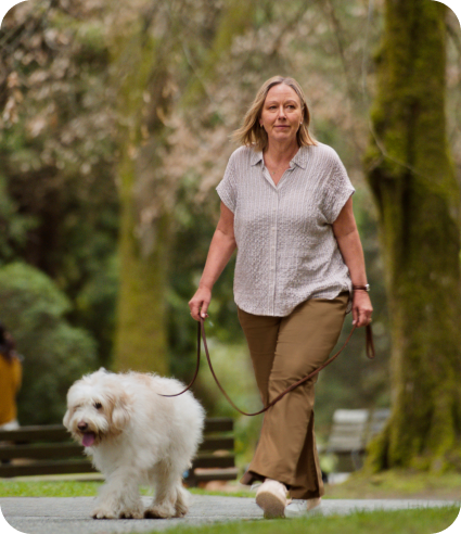 Woman walking her dog in the park