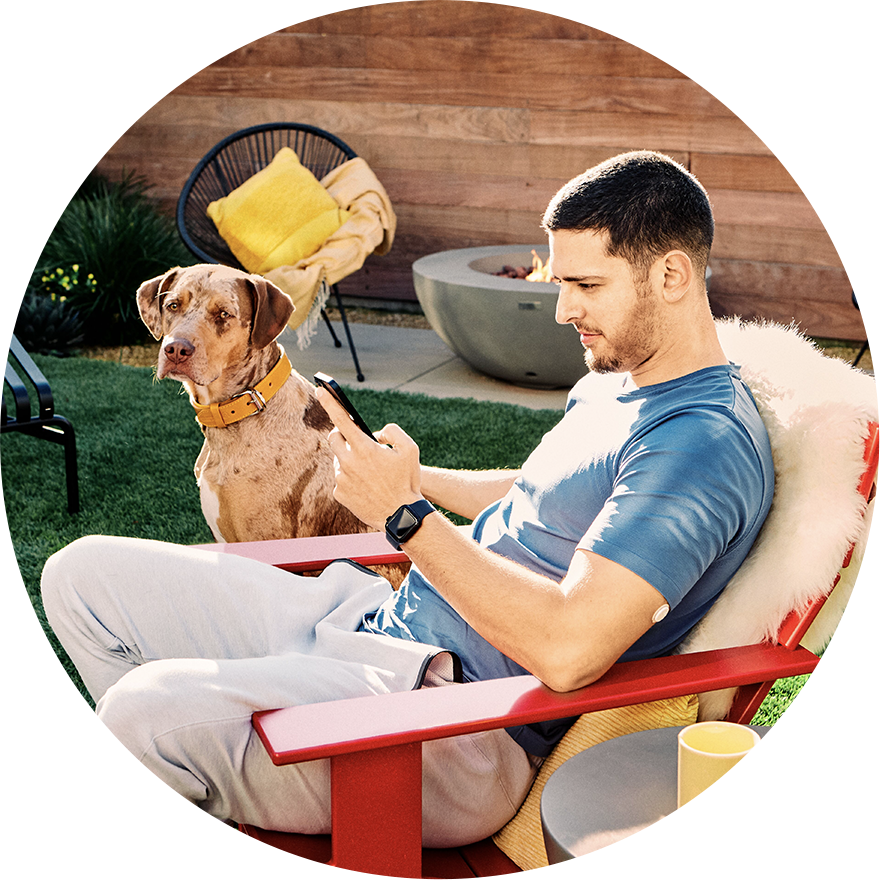 Man wearing Libre 3 sensor looking at his mobile device