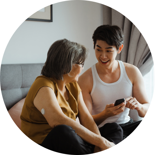 a woman and a man looking at Librelink Up data together
