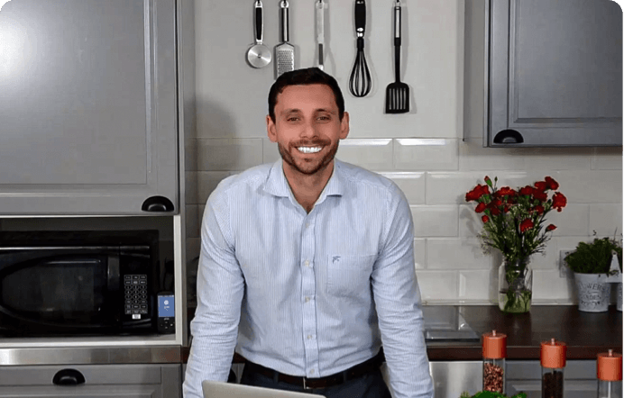 Mark, blog author, standing in the kitchen in front of his laptop smiling