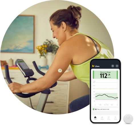 Woman wearing a FreeStyle Libre continuous glucose monitoring (CGM) sensor while riding a stationary bike