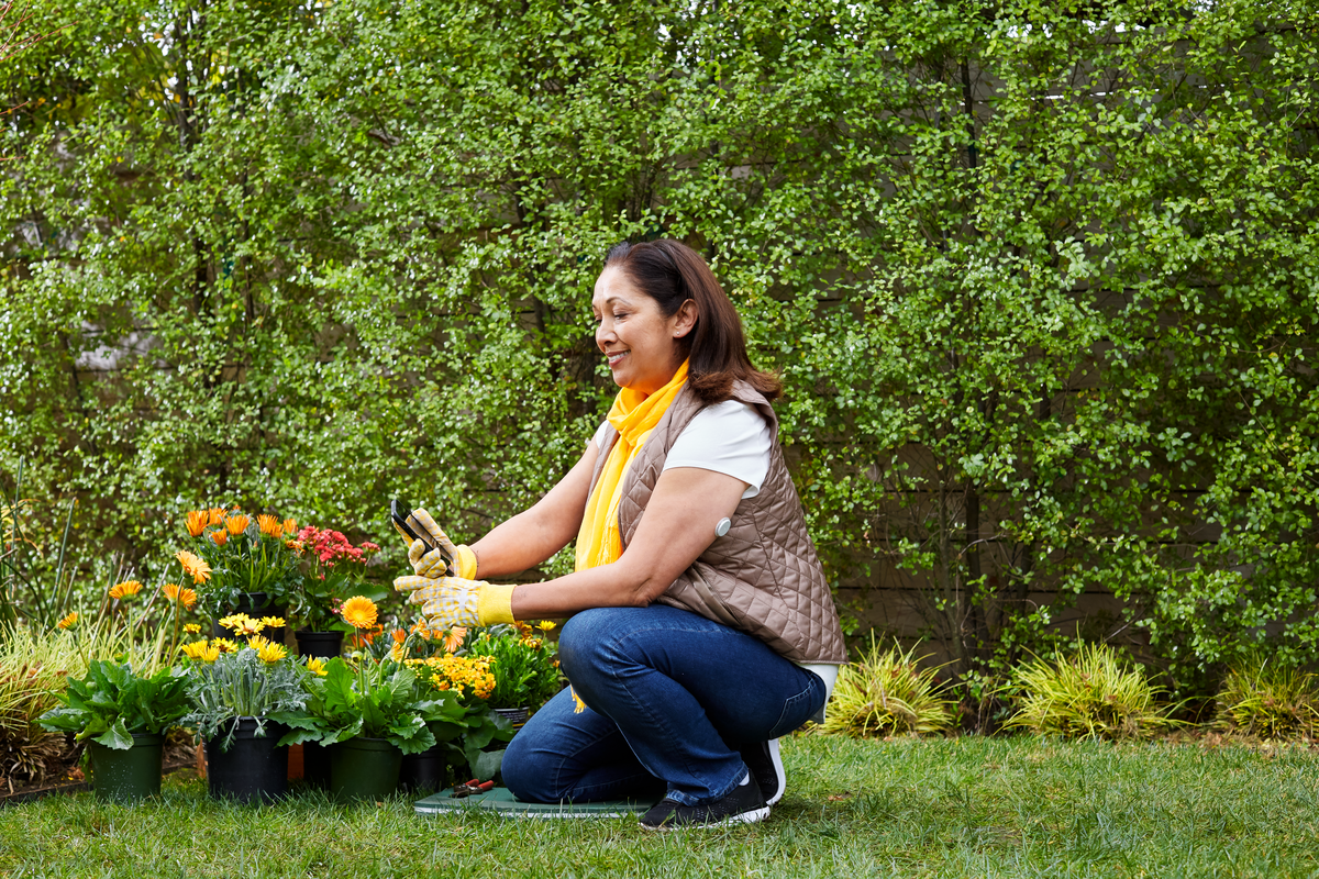 Woman gardening while wearing a FreeStyle Libre sensor